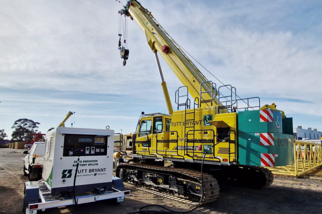 SANY SPL210 BESS recharging a SANY SCC400TB-EV Electric Crawler Crane on an outdoor worksite.